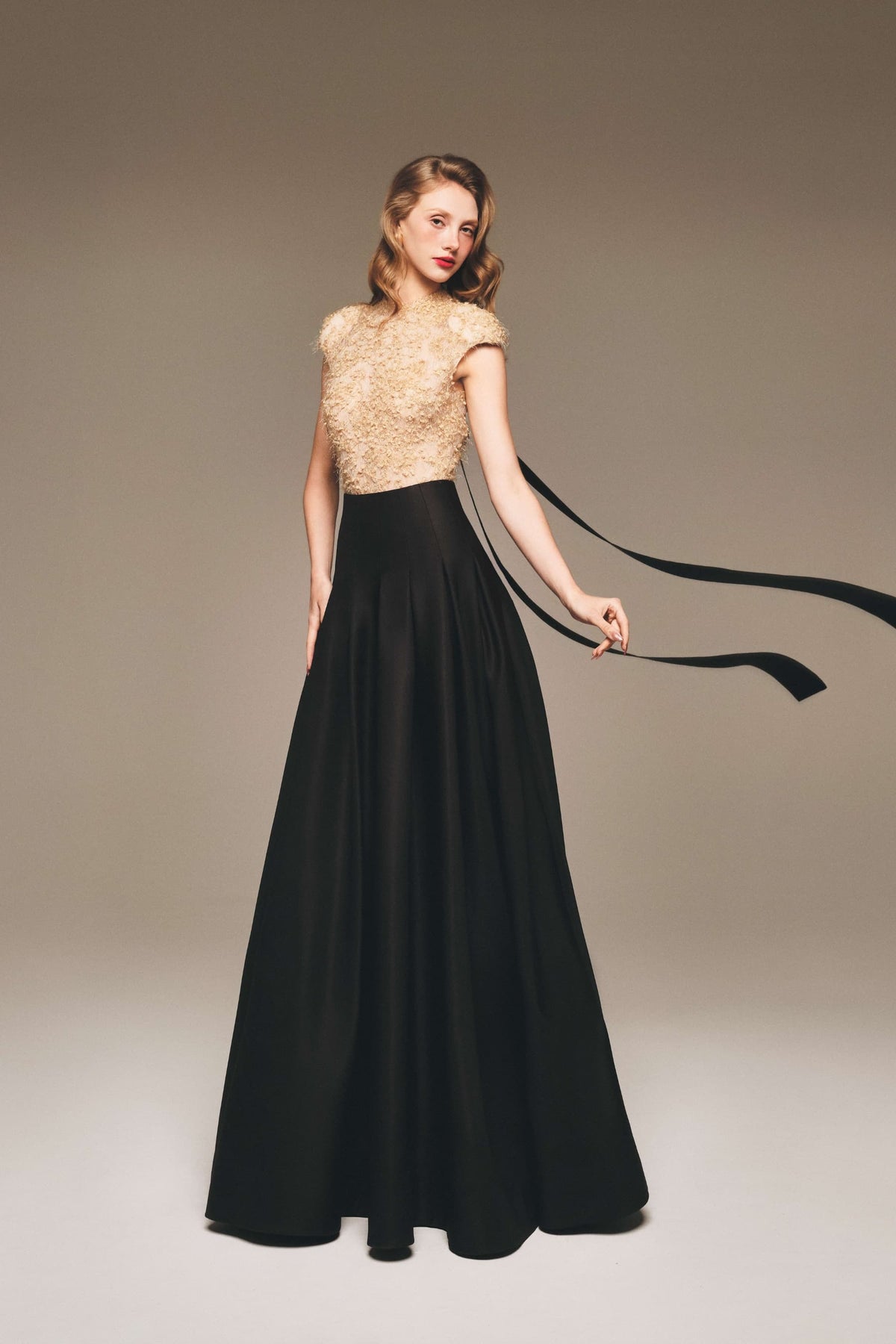 Margée Atelier pale lace top with a black taffeta maxi skirt and long neckline bow ties