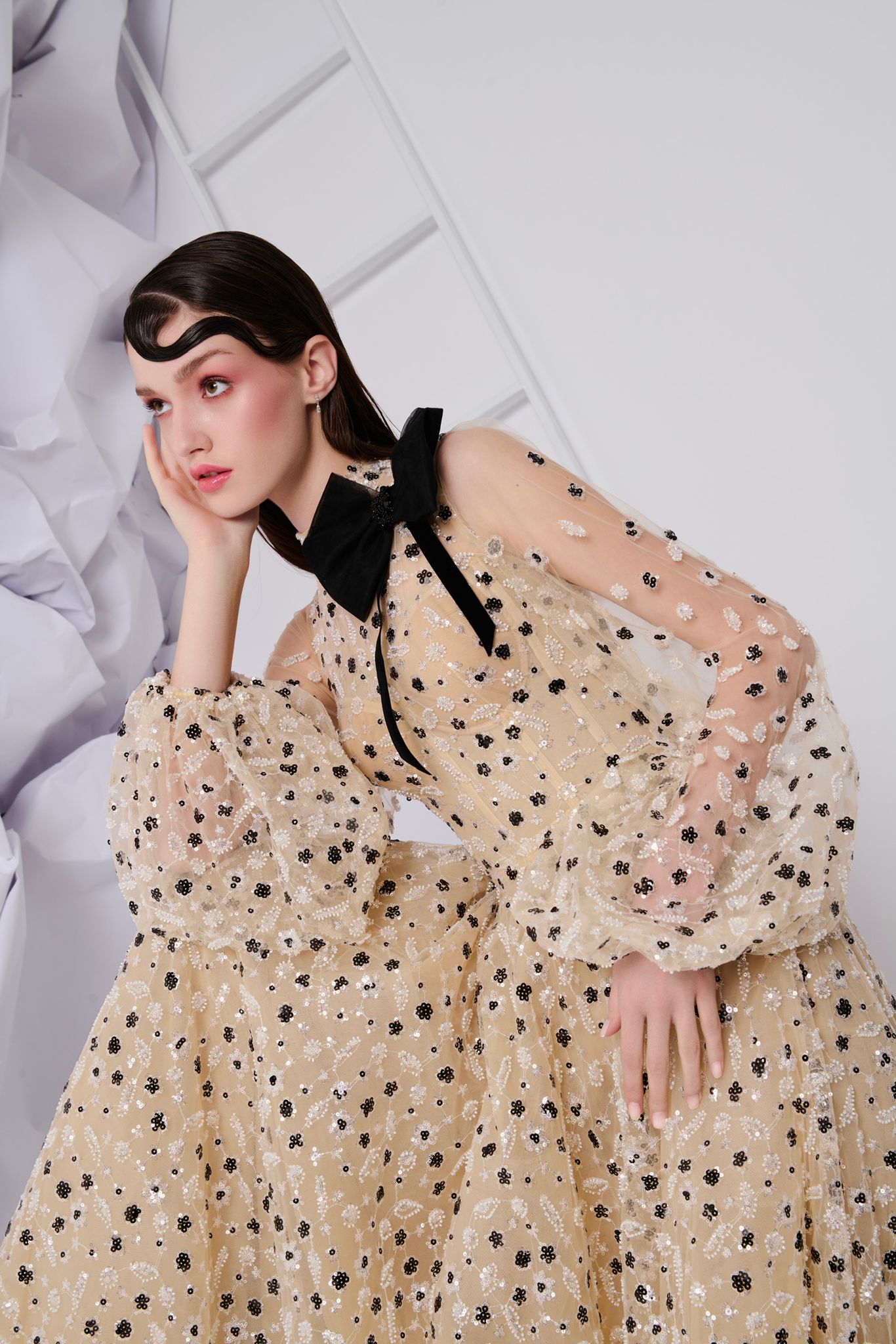 Li Beirut M1104 – High-Neck Illusion Gown with Floral Embellishments, Statement Bow & Sheer Sleeves