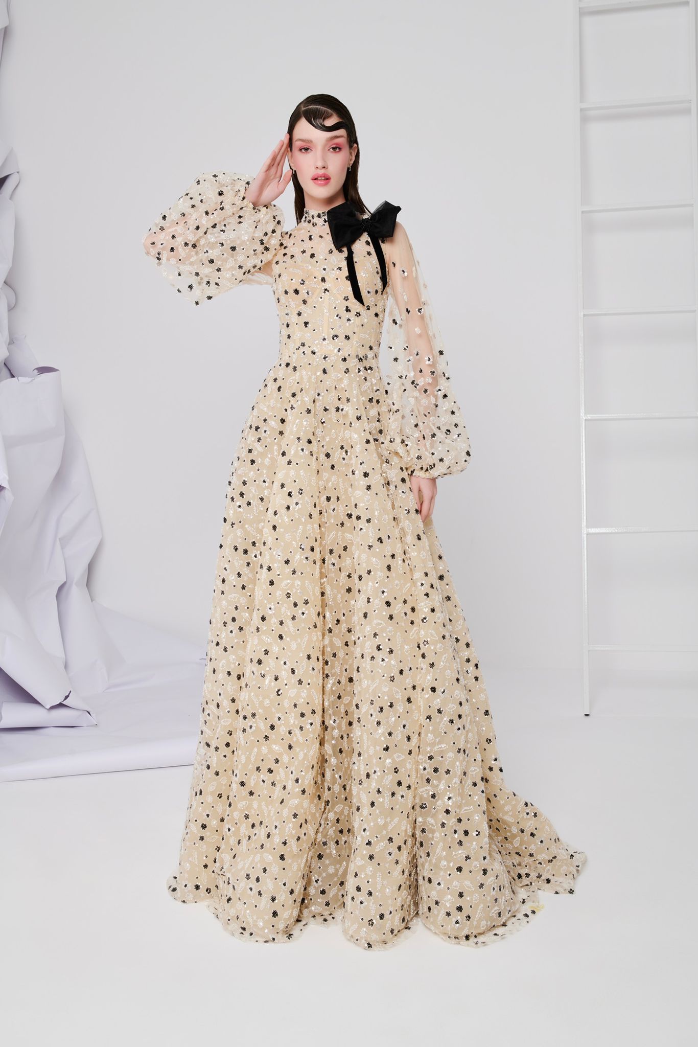 Li Beirut M1104 – High-Neck Illusion Gown with Floral Embellishments, Statement Bow & Sheer Sleeves