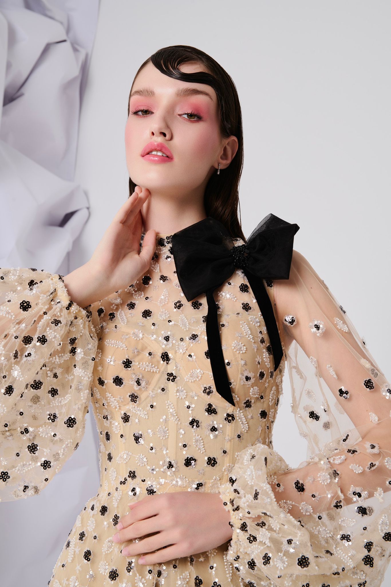 Li Beirut M1104 – High-Neck Illusion Gown with Floral Embellishments, Statement Bow & Sheer Sleeves