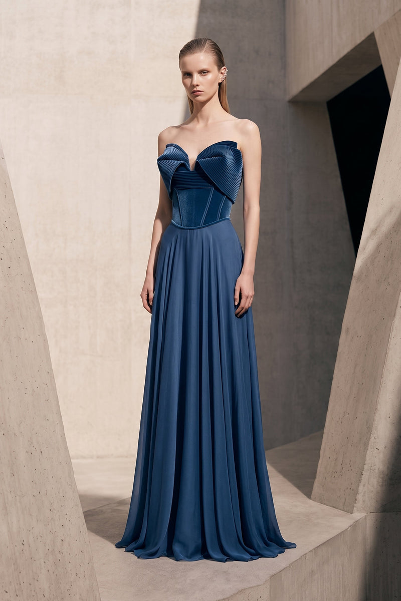 Elie The Label E189 blue strapless gown with folded pleated neckline panels and an A-line skirt