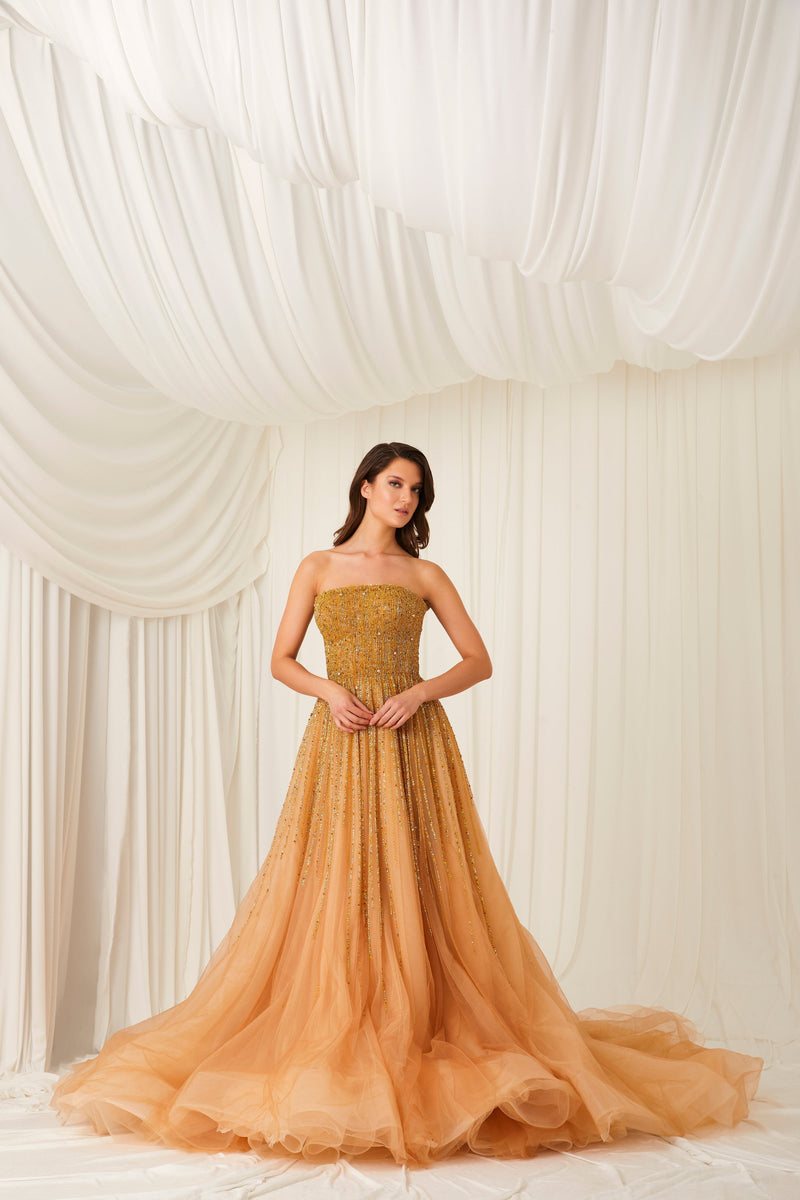 Li Beirut M1002 – Strapless Embellished Gold Ball Gown with Beaded Cape Overlay