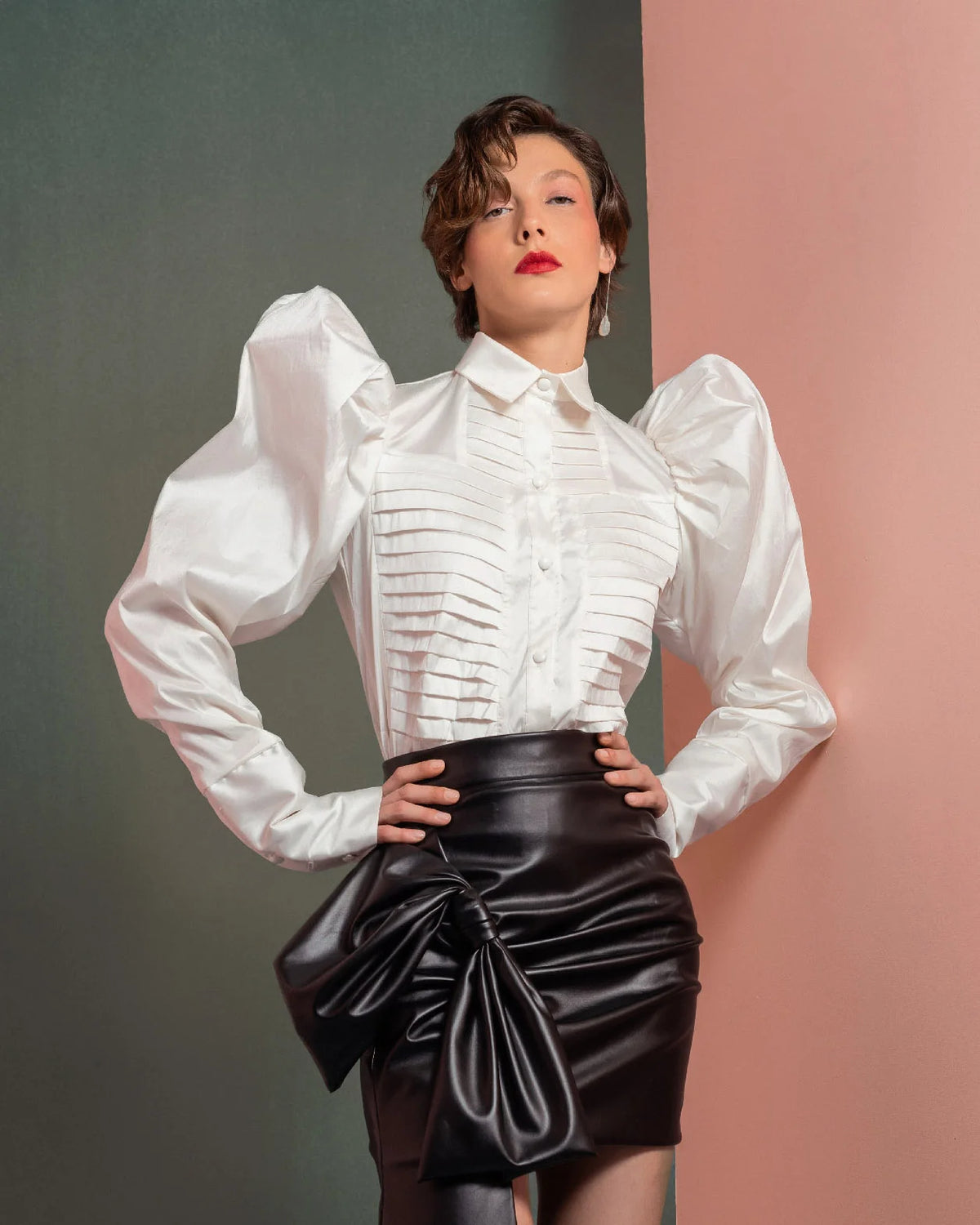 Style GOF2502 Puff-Shoulders Taffeta Blouse with Pleated Front Asymmetrical Leather Skirt with Bold Side Bow