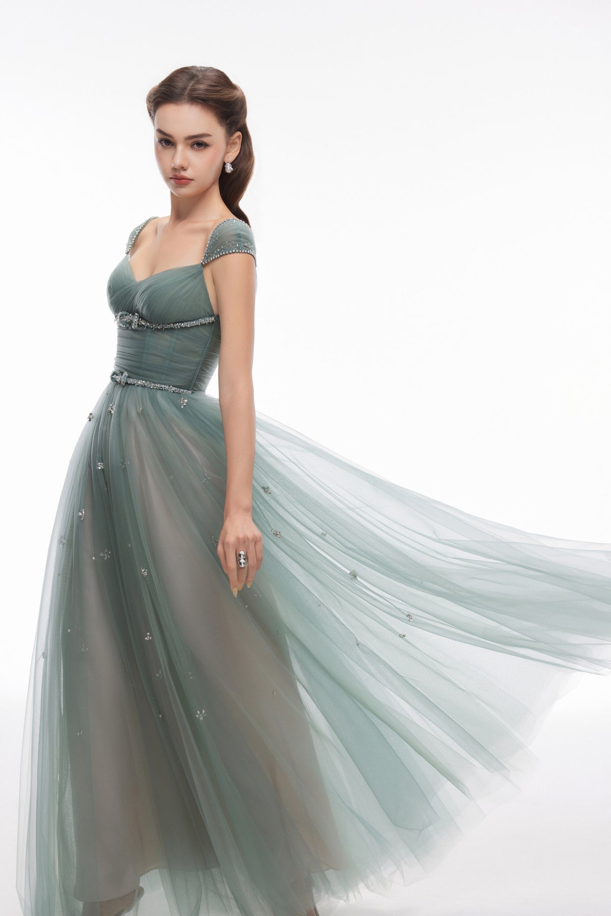 NEALA green embellished gown showing the flowing layered skirt and fitted ruched bodice