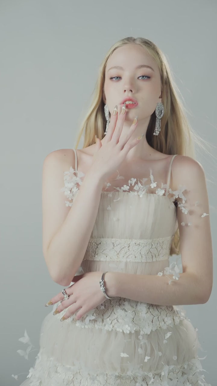 Joséphine PEARLIE dress close-up of white floral and lace embellishment.